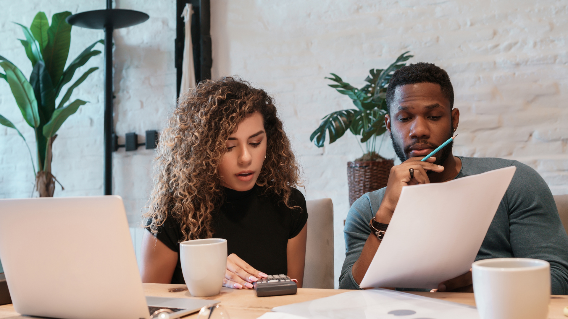 Couple creating budget using Victory Mortgage's Calculator 
