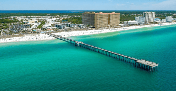 Scenic wooden boardwalk leading toward the beach in Panama City Beach, showcasing easy coastal access near Coral Cove