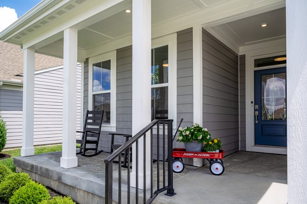 Covered front porch of the 2026 Cincinnati St. Jude Dream Home by Fischer Homes featuring welcoming outdoor living space and charming curb appeal.